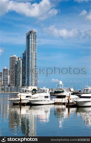 Luxury yachts on the background of skyscrapers with water reflection