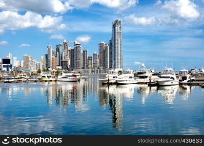 Luxury yachts on the background of skyscrapers with water reflection - Panama City