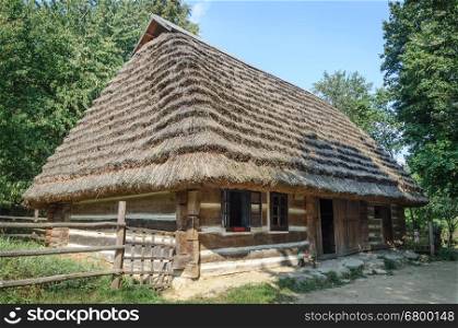 Lviv, Ukraine - September 09, 2016: Old Ukrainian authentic wooden house with thatched roof from Mshanets village, Lviv region, Ukraine. Now in Museum of Folk Architecture in Lviv