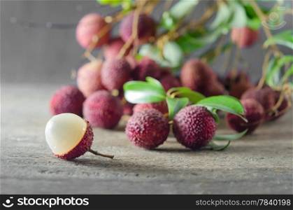 Lychee with leaves on a wooden table