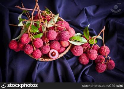 lychees on table and black background, fresh ripe lychee fruit tropical fruit peeled lychees slice in Thailand - top view 