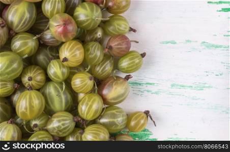 Lying gooseberry on a wooden table to one side of the frame. Ripe gooseberry on a wooden table