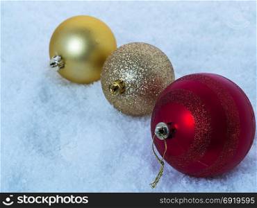 Lying in the snow multicolored Christmas tree decorations