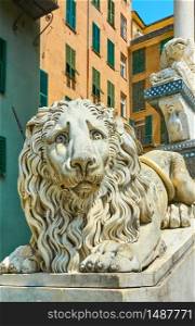 Lying marble lion - Statue at the entrance of San Lorenzo Cathedral in Genoa (Genova), Italy