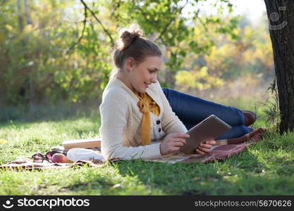 Lying woman on mat using tablet computer