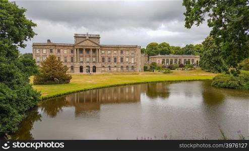 Lyme Hall and its pond. It is a historic English stately home inside Lyme Park in Cheshire, England.