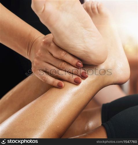 Lymphatic drainage massage. Hands of a masseuse massaging leg of a female client. Lymphatic Drainage Massage