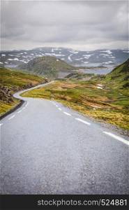 Lysevegen road running through summer norwegian mountains, located in Rogaland county. Beautiful landscape. Travel and tourism.. Road landscape in norwegian mountains