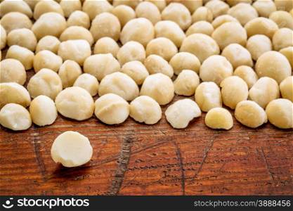 macadamia nuts on rustic grunge wood wood with a selective focus