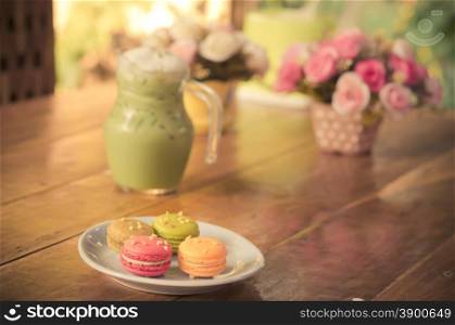Macaron and iced green tea on the table.film style color effect