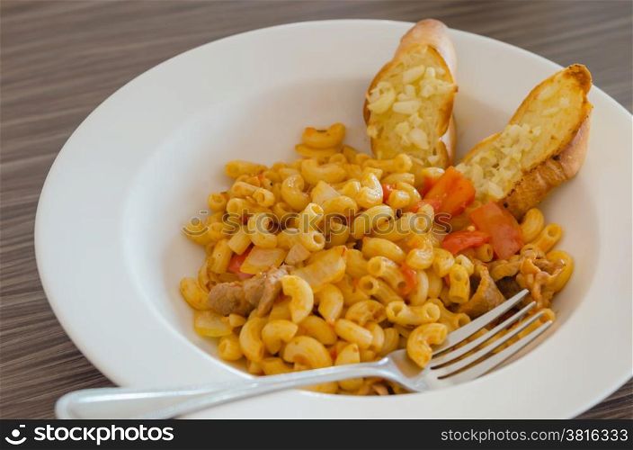 macaroni. Italian tomato pasta served with garlic bread
