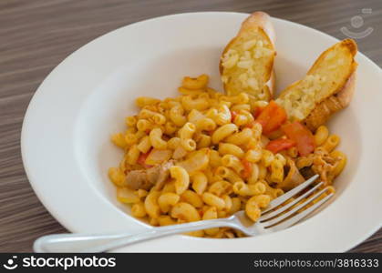 macaroni. Italian tomato pasta served with garlic bread