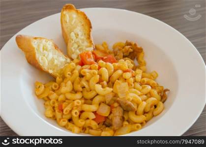 macaroni. Italian tomato pasta served with garlic bread