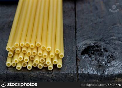 Macaroni pasta on dark rustic wood.. Macaroni pasta on dark rustic wood