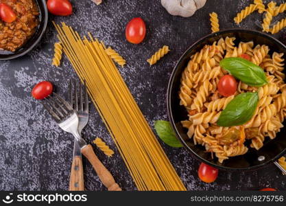Macaroni sauteed with tomatoes and basil on the pan