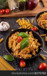 Macaroni sauteed with tomatoes and basil on the pan