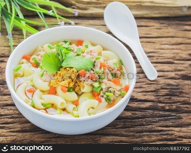 Macaroni soup putting on sack cloth and wooden background