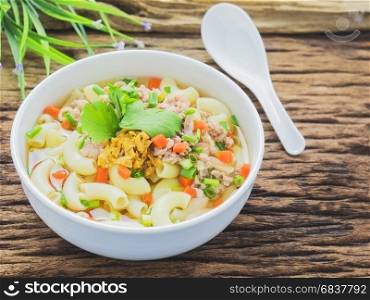 Macaroni soup putting on sack cloth and wooden background