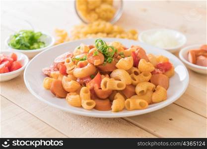 macaroni with sausage on wood table