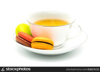 Macarons and a cup of tea on white background