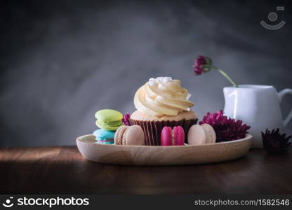 macarons or macaroons and cupcakes on wooden dessert sweet beautiful to eat.