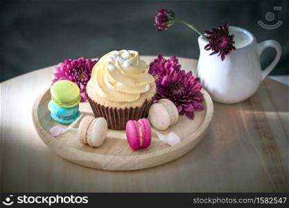 macarons or macaroons and cupcakes on wooden dessert sweet beautiful to eat.