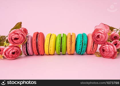 macarons with tender small roses. Sweets and desserts concept of macaroons