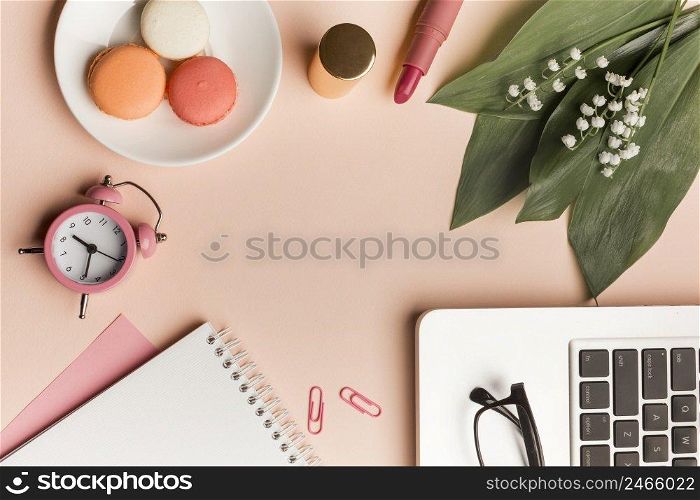 macaroons alarm clock lipstick leaves flower with spiral notepad laptop