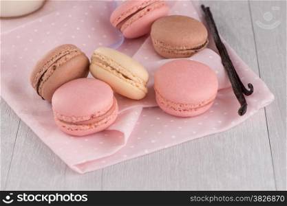 Macaroons closeup detail on wooden table.
