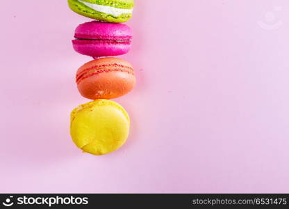 Macaroons cookies on pink. Macaroons cookies row on pink background with copy space