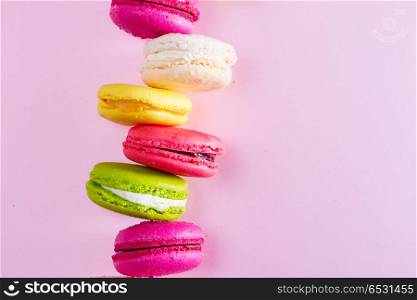 Macaroons cookies on pink. Macaroons cookies stack on pink background with copy space