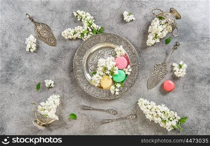 Macaroons. Creative food background. Vintage style flat lay with white lilac flowers