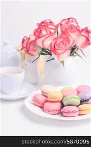 macaroons in gift box and roses in vase