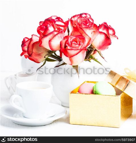 macaroons in gift box and roses in vase. macaroons in gift box
