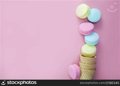Macaroons on colored pink background, composition of colorful french cookies macarons Gift for Valentine&rsquo;s Day Mothers Day top view copy space space for text. Macaroons on colored pink background, composition of colorful french cookies macarons Gift for Valentine&rsquo;s Day Mothers Day top view copy space