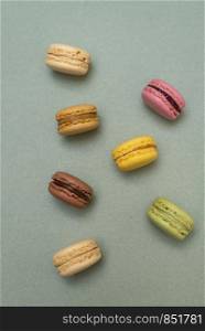 Macaroons on green background from above