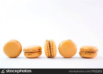 Macaroons on white background top, colorful yellow macaroons, selective focus.. Macaroons on white background top, colorful yellow macaroons, selective focus