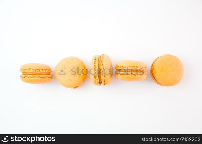 Macaroons on white background top, colorful yellow macaroons, selective focus.. Macaroons on white background top, colorful yellow macaroons, selective focus