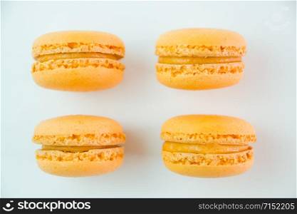 Macaroons on white background top, colorful yellow macaroons, selective focus.. Macaroons on white background top, colorful yellow macaroons, selective focus