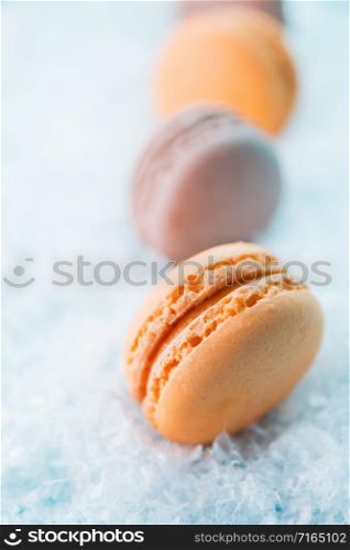 Macaroons on white snow background top, colorful macaroons, selective focus.. Macaroons on white snow background top, colorful macaroons, selective focus