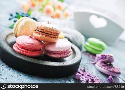 macaroons on wooden board and on a table