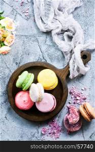 macaroons on wooden plate and on a table