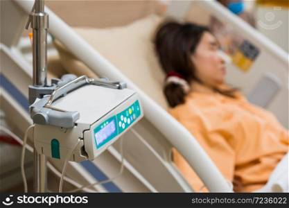 machine control saline solution with woman patient in hospital