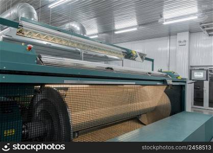 machine evaporates textile yarn. machinery and equipment in a textile factory. textile yarn processing shop