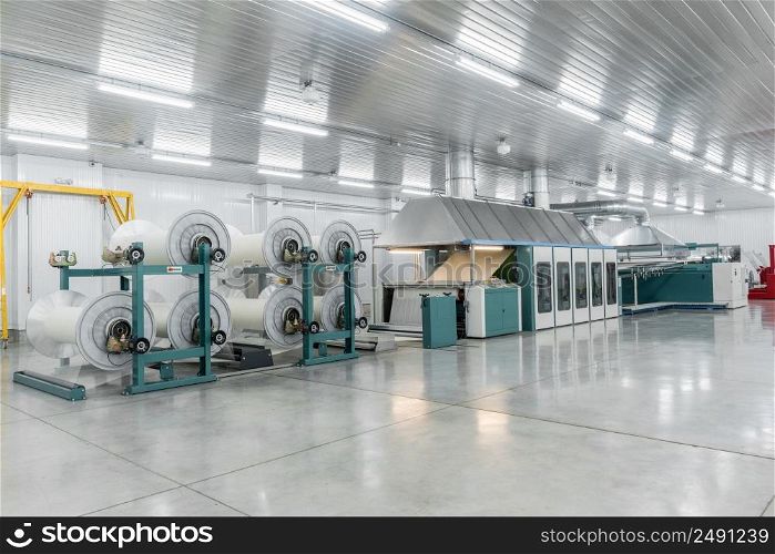 machine evaporates textile yarn. machinery and equipment in a textile factory. textile yarn processing shop