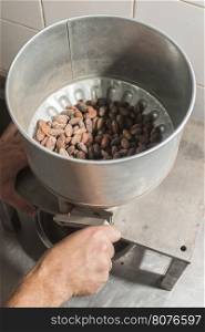 Machine for grinding cocoa. Hand grinding cocoa