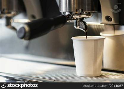 machine pouring coffee disposable cup