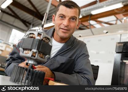 machine technician is smiling at the camera