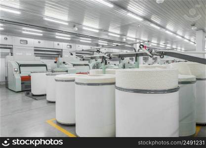 Machinery and equipment in the workshop for the production of thread, overview. interior of industrial textile factory. production of threads in a textile factory