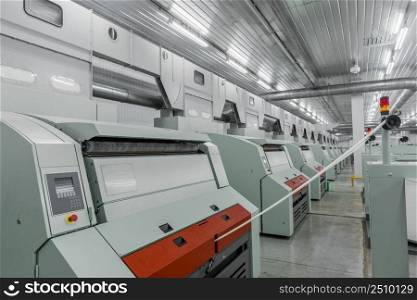 Machinery and equipment in the workshop for the production of thread, overview. interior of industrial textile factory. production of threads in a textile factory